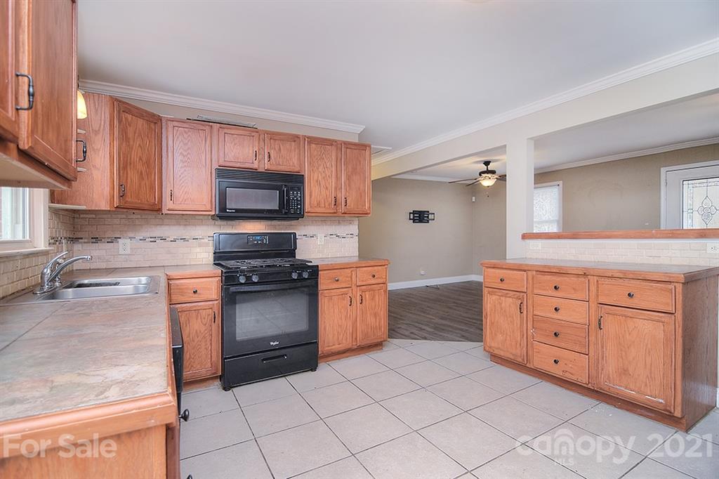 1100 Culp Street Lancaster, SC 29720 - Photo 14 of 30 a kitchen with granite countertop cabinets and steel stainless steel appliances