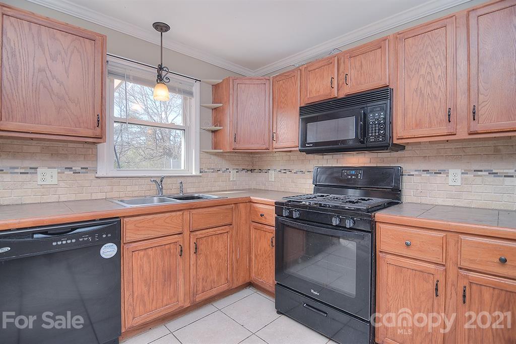 1100 Culp Street Lancaster, SC 29720 - Photo 15 of 30 a kitchen with granite countertop cabinets stainless steel appliances and a sink