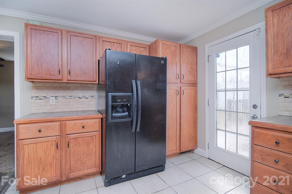 1100 Culp Street Lancaster, SC 29720 - Photo 16 of 30 a kitchen with stainless steel appliances granite countertop a refrigerator and cabinets