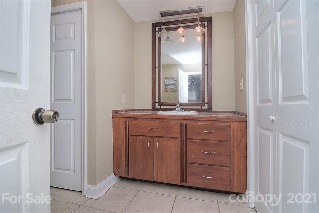 1100 Culp Street Lancaster, SC 29720 - Photo 20 of 30 a bathroom with a granite countertop sink and a mirror
