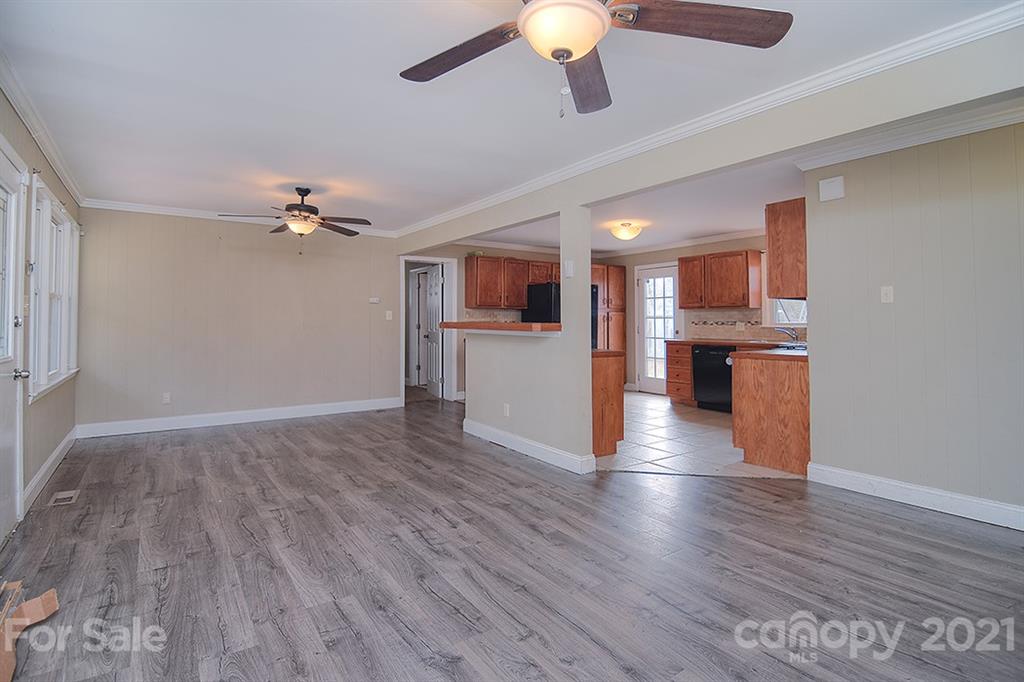 1100 Culp Street Lancaster, SC 29720 - Photo 9 of 30 a view of a livingroom with a ceiling fan wooden floor and kitchen