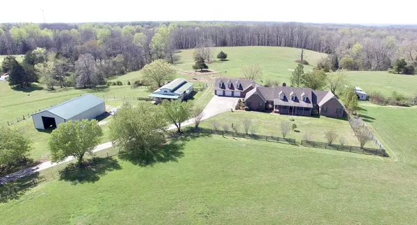 an aerial view of a house with garden space and seating area