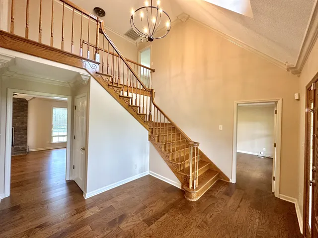 a view of entryway and hall with wooden floor