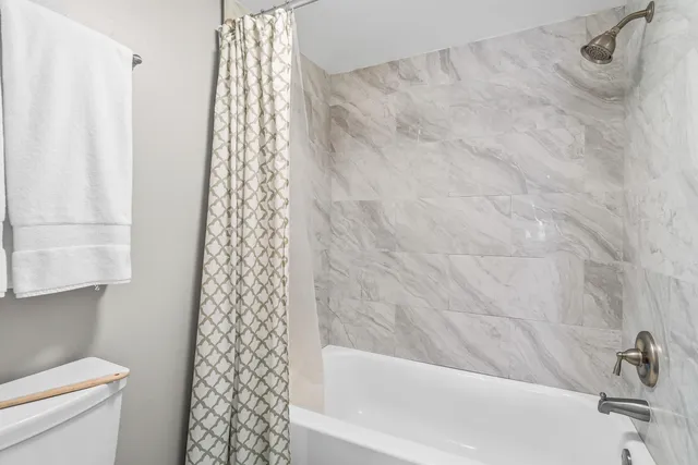 a bathroom with a bathtub and shower