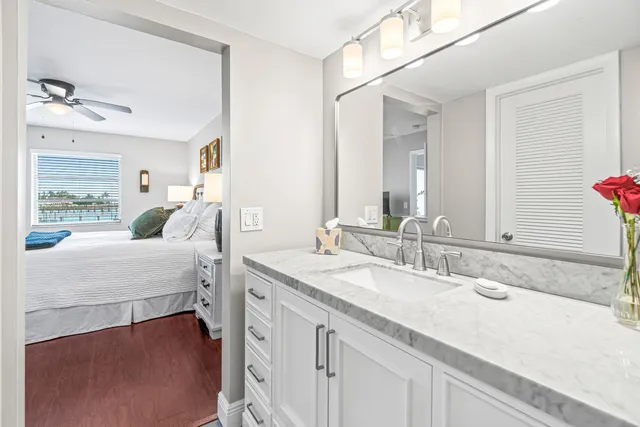 a en suite bathroom with a double vanity sink and a mirror