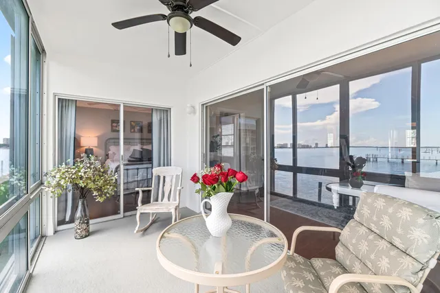 a dining room with furniture potted plants and wooden floor