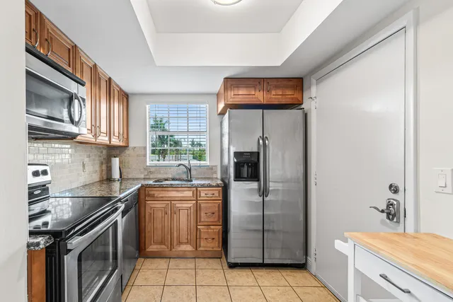 a kitchen with a sink a refrigerator and washer