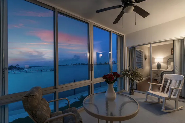 a living room with furniture kitchen view and a table