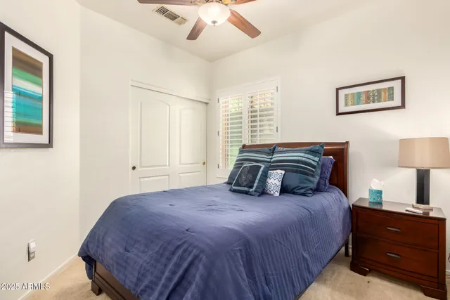 a bedroom with a bed and a night stand