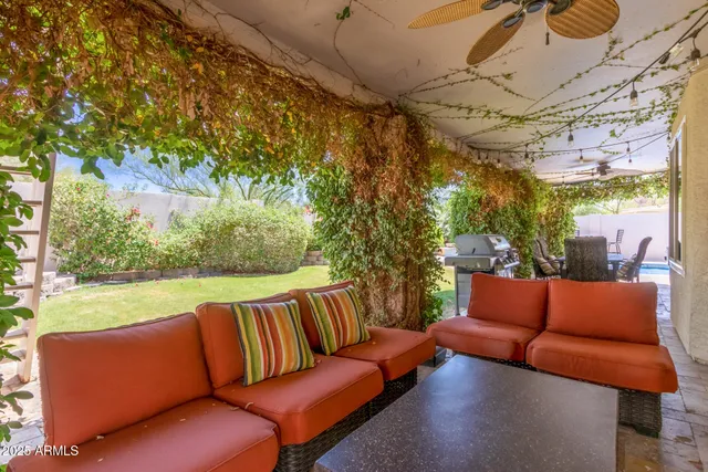 a outdoor living space with furniture and a black umbrella