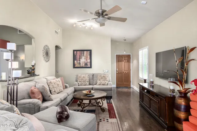 a living room with furniture and a flat screen tv