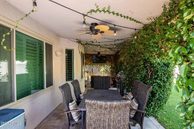 a view of a patio with couches table and chairs and potted plants