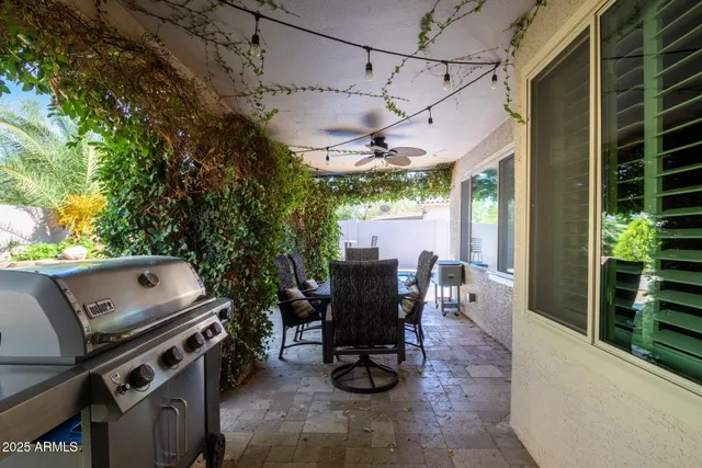 a view of a patio with table and chairs