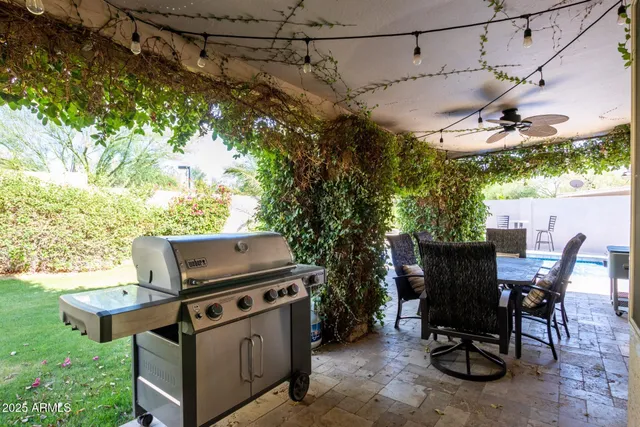 a view of a patio with a table and chairs