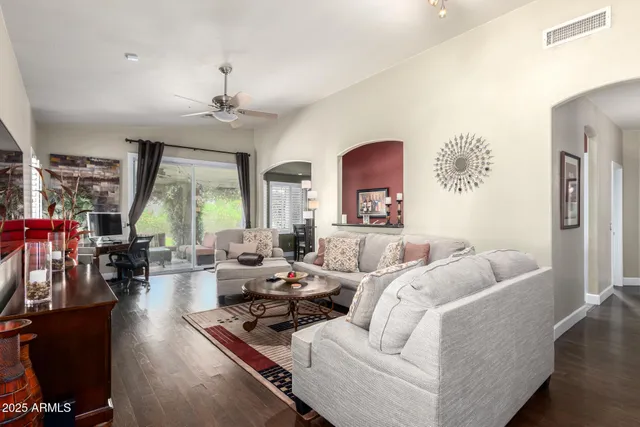 a living room with furniture and a chandelier