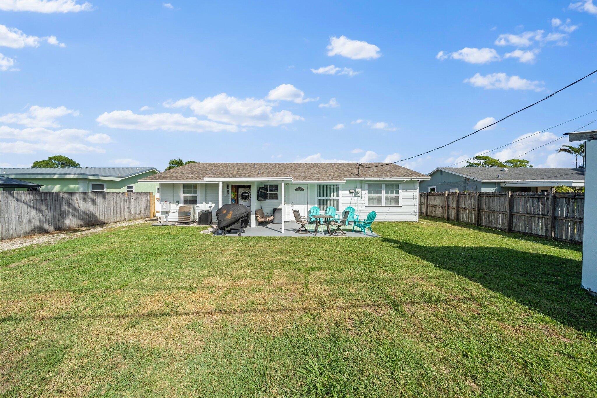 5810 Tucker Road Jupiter, FL 33458 - Photo 2 of 51 a view of a house with a yard