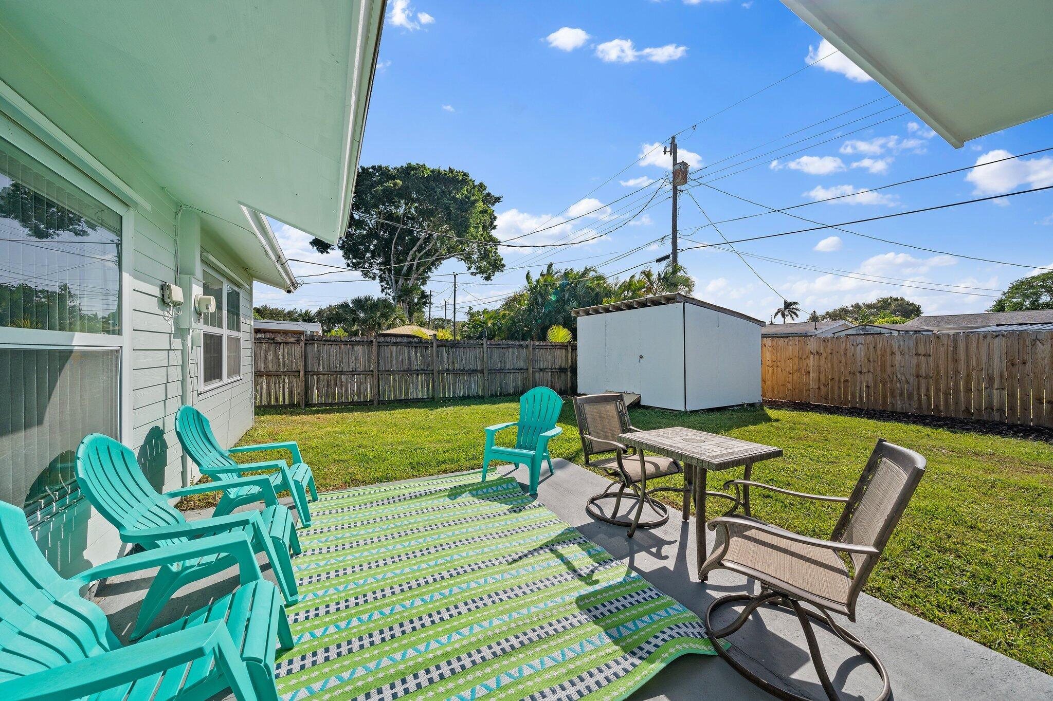5810 Tucker Road Jupiter, FL 33458 - Photo 24 of 51 a view of a chairs and table in patio with wooden fence