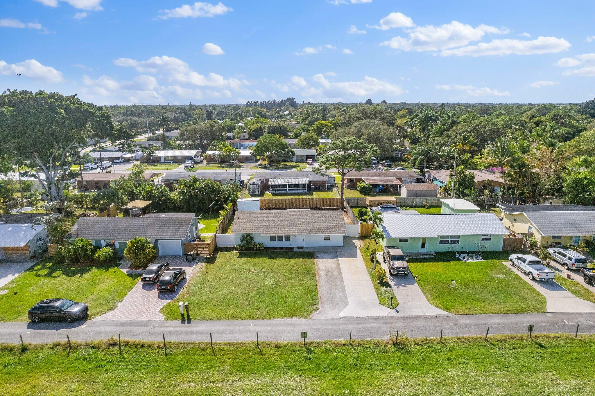 5810 Tucker Road Jupiter, FL 33458 - Photo 30 of 51 an aerial view of a house with a garden