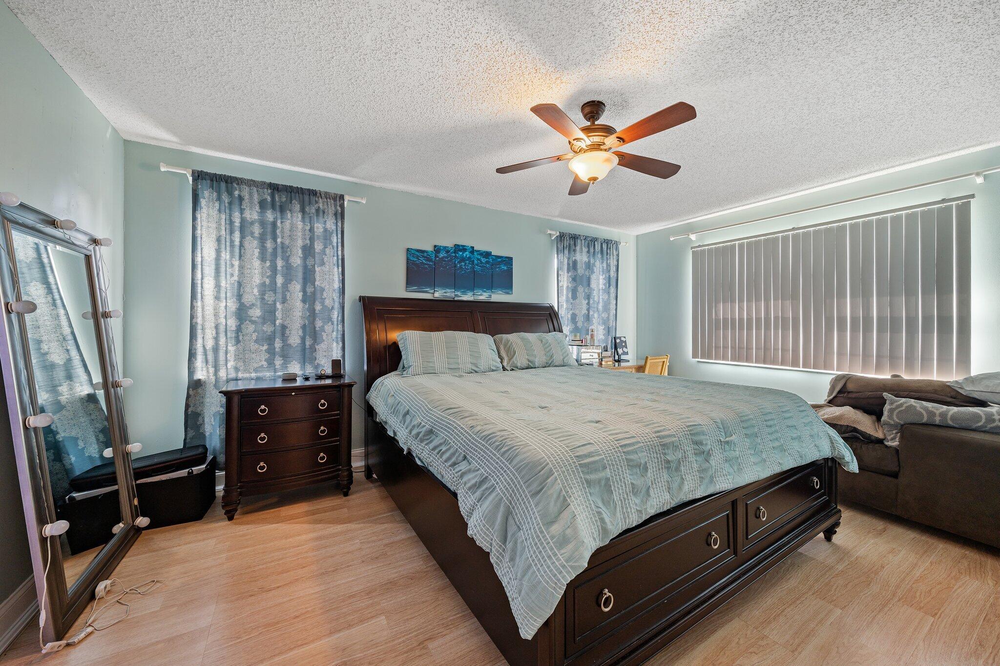 5810 Tucker Road Jupiter, FL 33458 - Photo 6 of 51 a bedroom with a bed dresser and a window