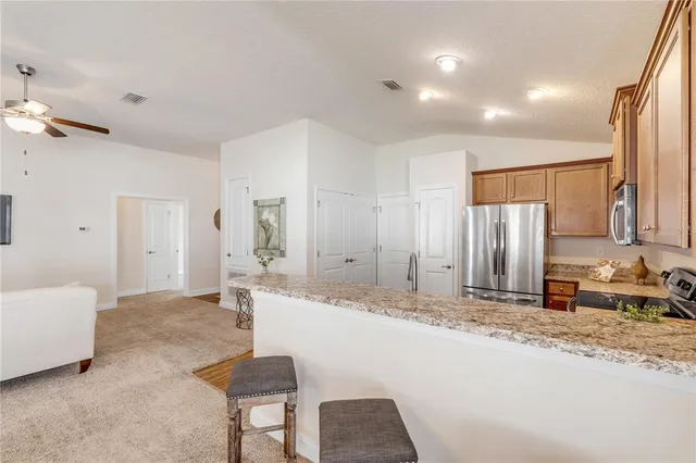 a living room with kitchen island furniture and a chandelier