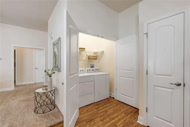 a room view with a chandelier and wooden floor
