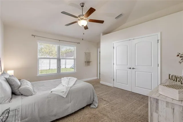 a bedroom with a large bed and a chandelier