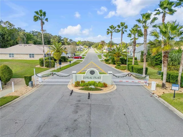 a view of a house with a swimming pool and a yard