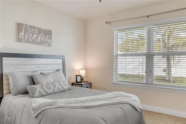 a bedroom with a large bed and a window