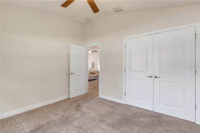 an empty room with ceiling fan