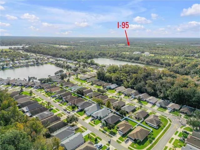 an aerial view of a house with a swimming pool outdoor seating and yard