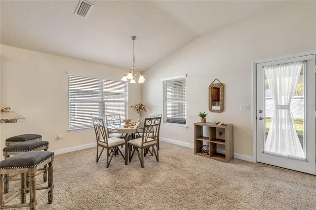 a view of a dining room with furniture window and outside view