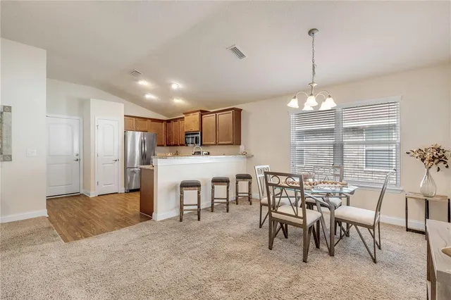 a view of a dining room with furniture window and outside view