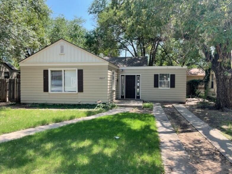 2607 27th Street Lubbock, TX 79410 - Photo 1 of 13 a front view of a house with a yard and garage