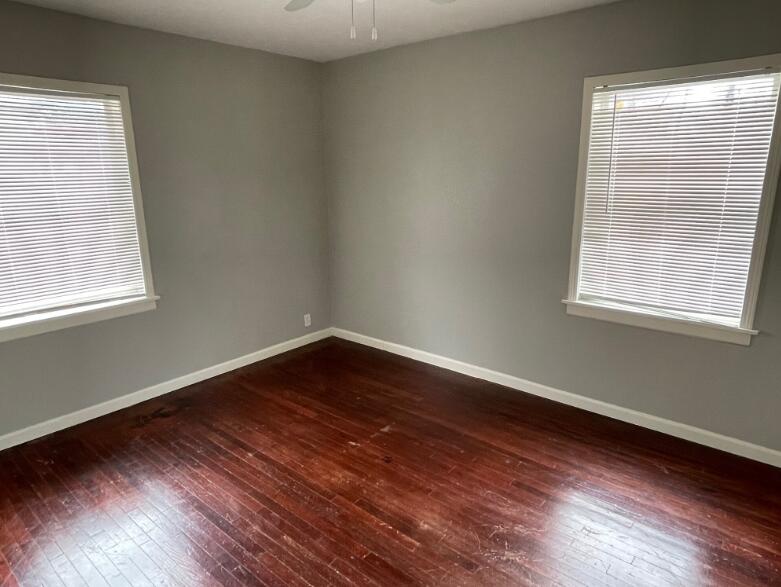 2607 27th Street Lubbock, TX 79410 - Photo 8 of 13 a view of an empty room with wooden floor and a window