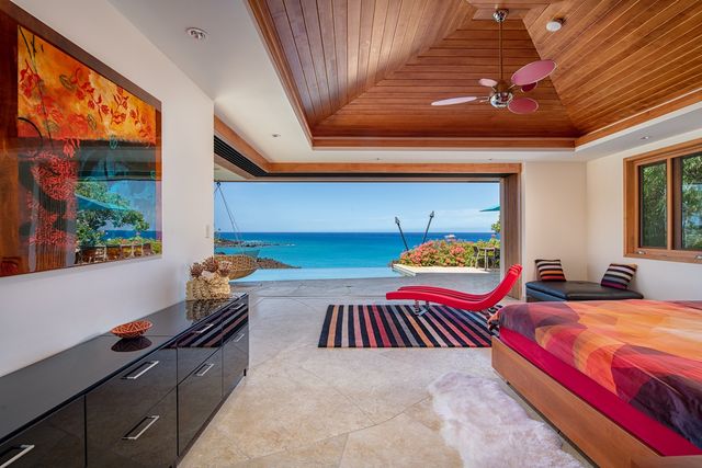 a bedroom with two beds and a large window