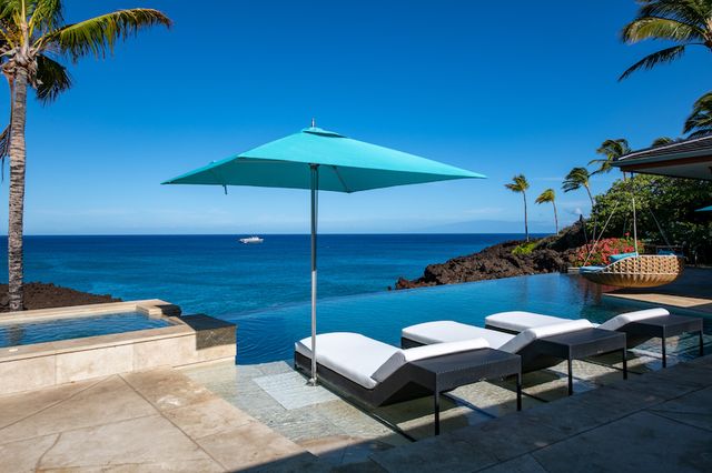 a backyard of a house with table and chairs