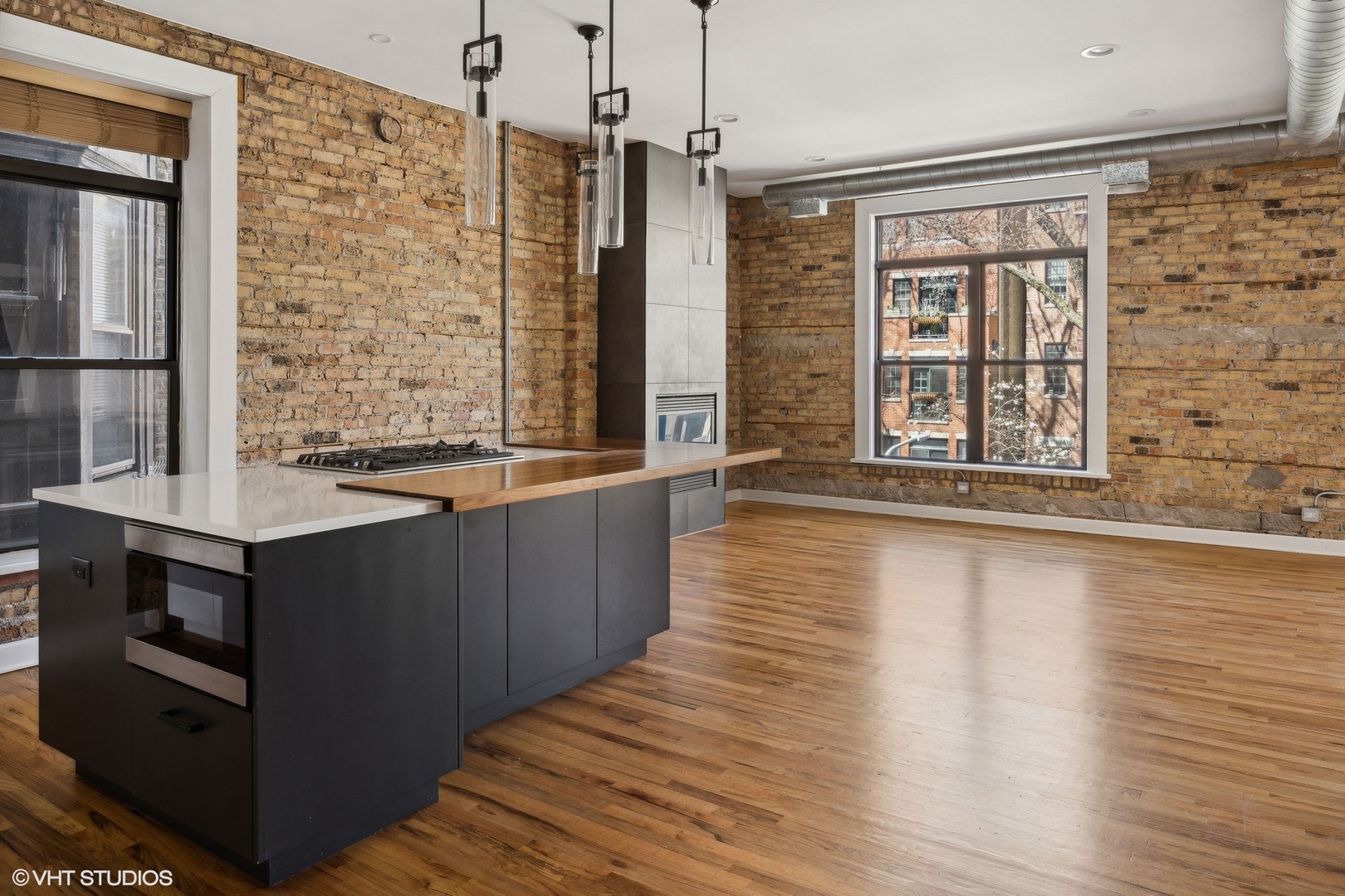 717 West Briar Place, Unit 2W Chicago, IL 60657 - Photo 13 of 26 a view of kitchen with granite countertop cabinets and wooden floor