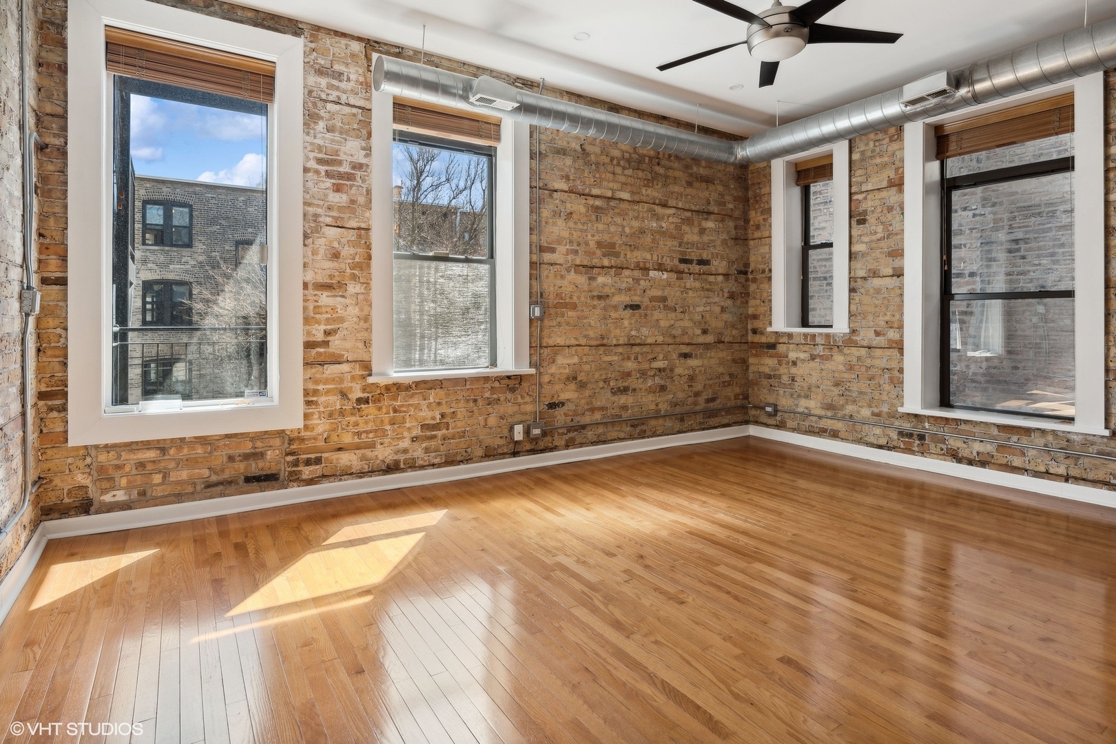 717 West Briar Place, Unit 2W Chicago, IL 60657 - Photo 20 of 26 a view of a livingroom with wooden floor and a large window