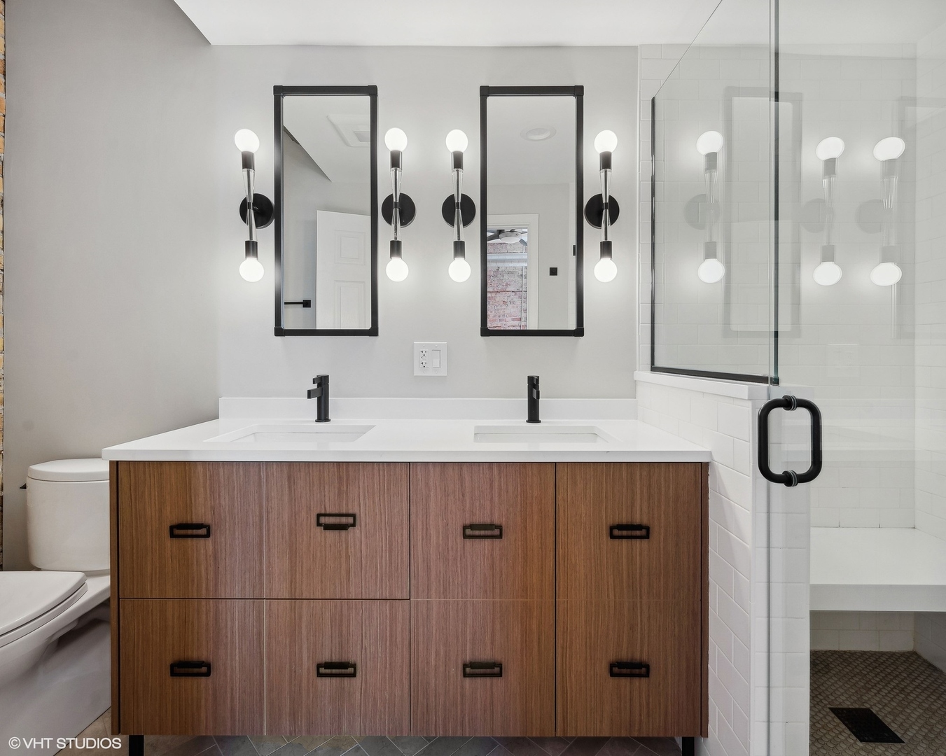 717 West Briar Place, Unit 2W Chicago, IL 60657 - Photo 21 of 26 a bathroom with a double vanity sink mirror and shower
