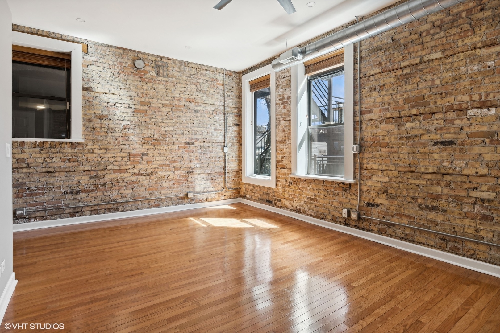 717 West Briar Place, Unit 2W Chicago, IL 60657 - Photo 22 of 26 a view of a livingroom with wooden floor and a window