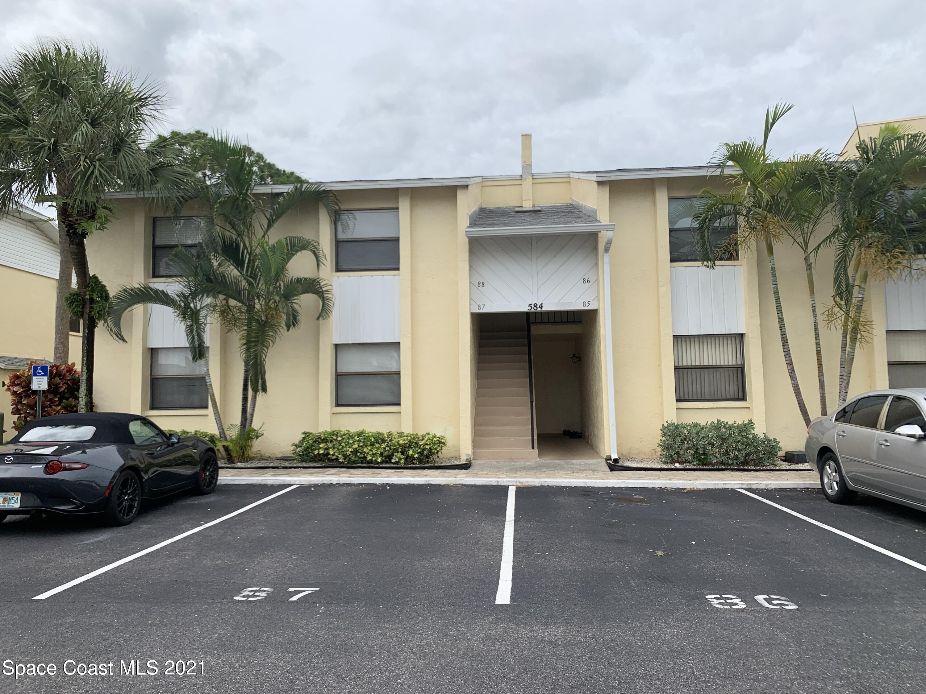 584 North Wickham Road, Unit 86 Melbourne, FL 32935 - Photo 1 of 12 a couple of cars parked in front of a house