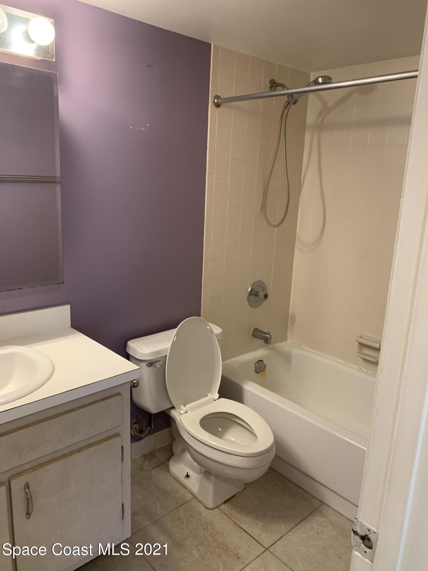 584 North Wickham Road, Unit 86 Melbourne, FL 32935 - Photo 11 of 12 a bathroom with a toilet a sink and a shower