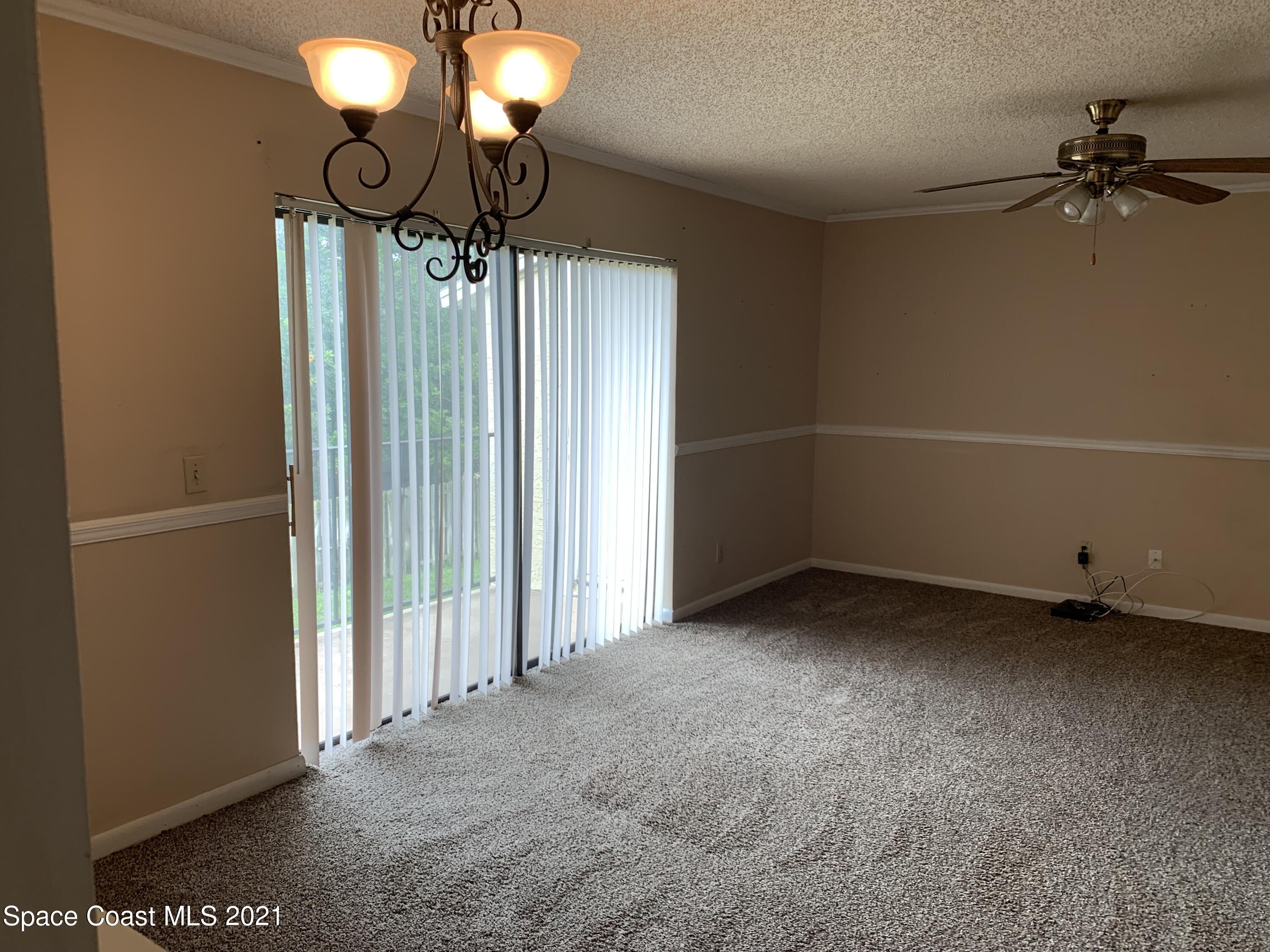 584 North Wickham Road, Unit 86 Melbourne, FL 32935 - Photo 5 of 12 a view of a livingroom with a fan
