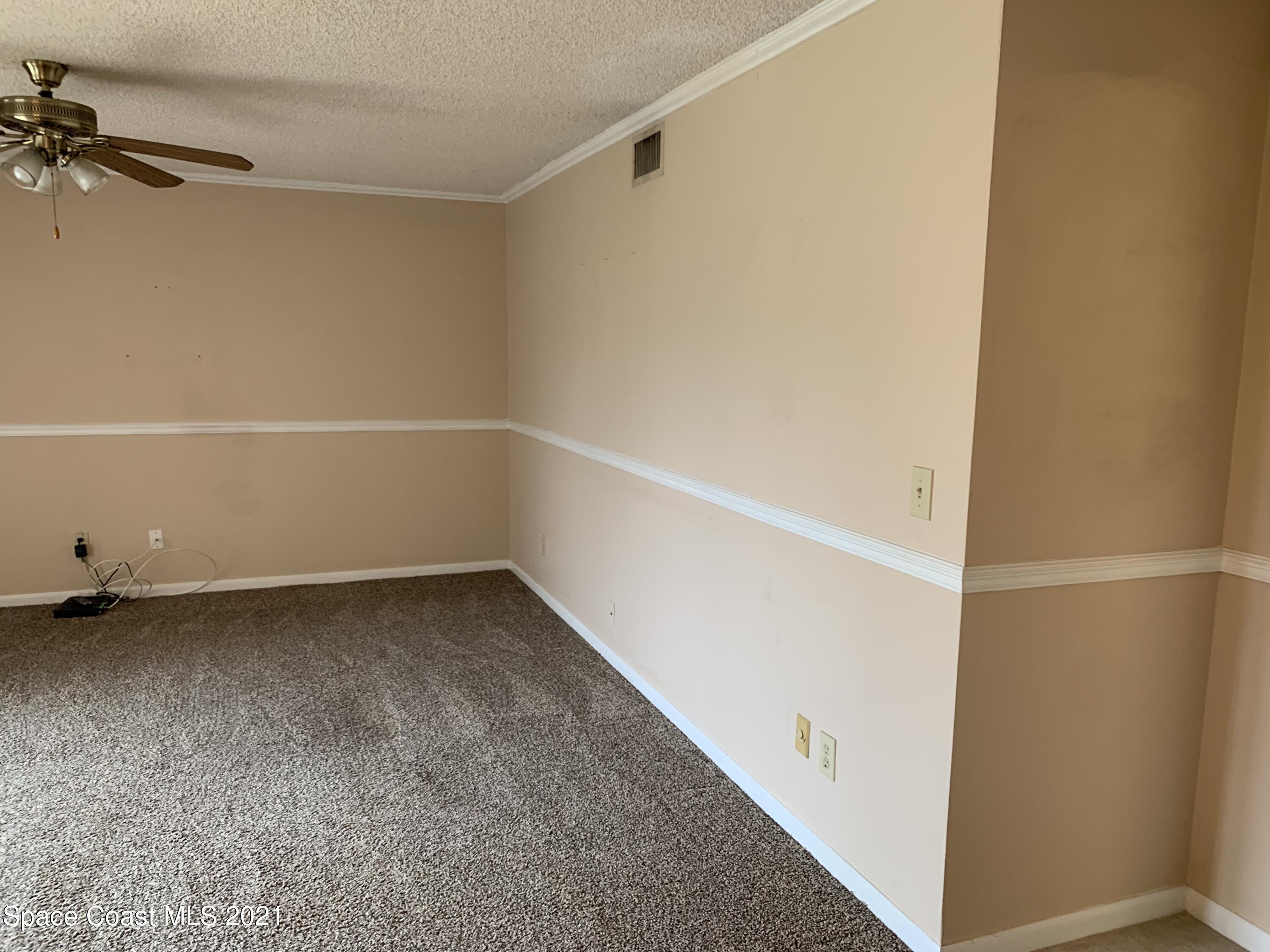 584 North Wickham Road, Unit 86 Melbourne, FL 32935 - Photo 6 of 12 a view of a room with racks on the wall