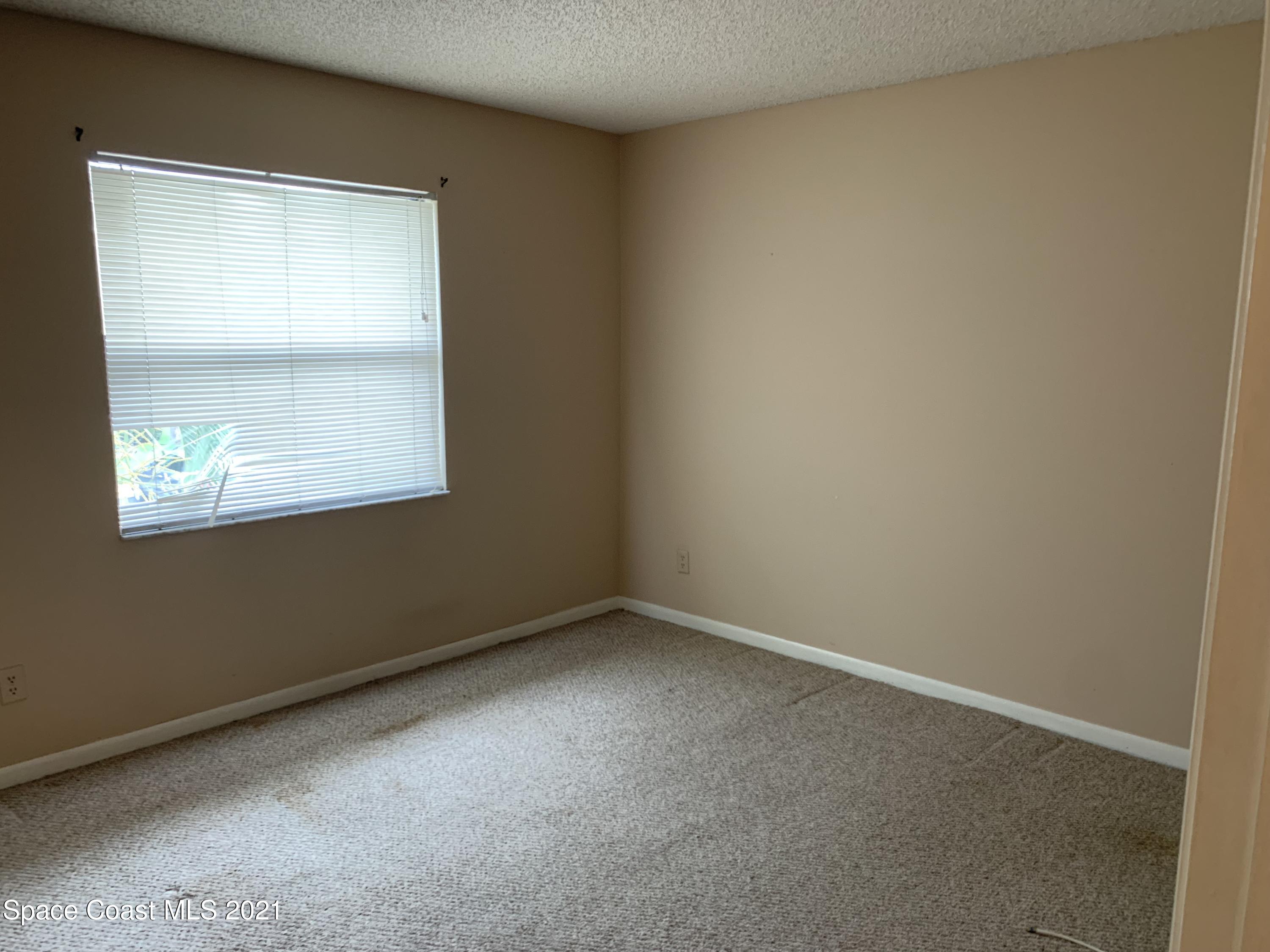 584 North Wickham Road, Unit 86 Melbourne, FL 32935 - Photo 9 of 12 an empty room with a window