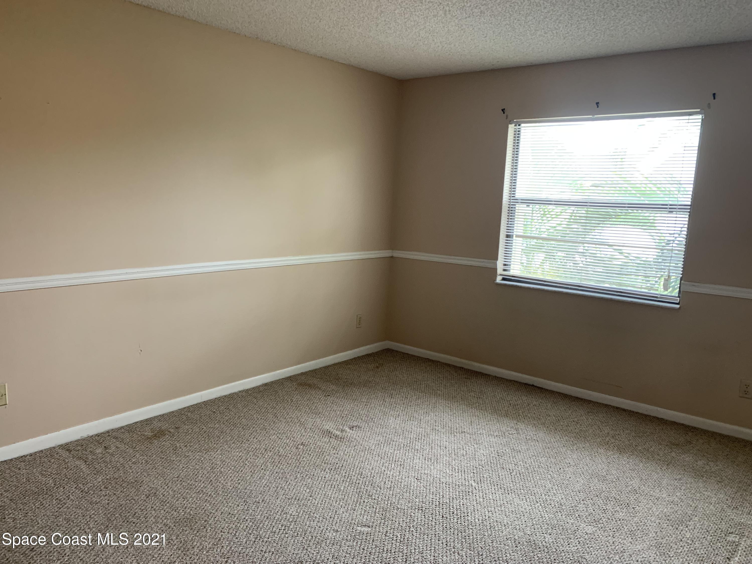 584 North Wickham Road, Unit 86 Melbourne, FL 32935 - Photo 10 of 12 an empty room with a window