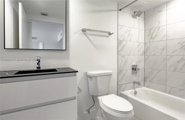 a kitchen with stainless steel appliances a refrigerator a stove a sink and a window