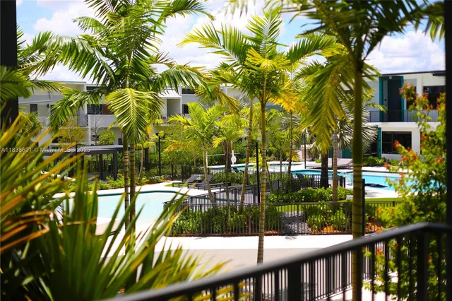 a kitchen with a large window stainless steel appliances and wooden floor