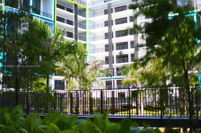 a view of a swimming pool with a garden and trees
