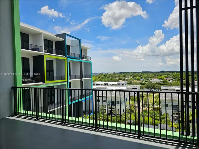 a view of an empty room with a large window and cabinet